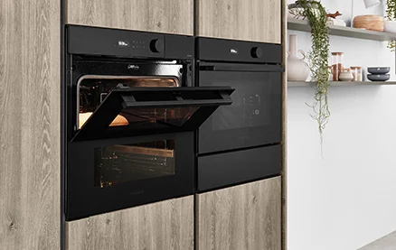 Compact appliance with steam oven in modern nobilia kitchen with RIVA 843 front in Sierra oak reproduction. Stylish appliance integration for healthy and gentle preparation.